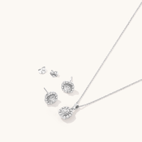This stunning 45cm cushion shape halo pendant necklace and stud earrings two-piece set features 0.15ct total weight of diamonds in sterling silver. Suspended from a 1mm 45cm rope chain, this necklace Bevilles 