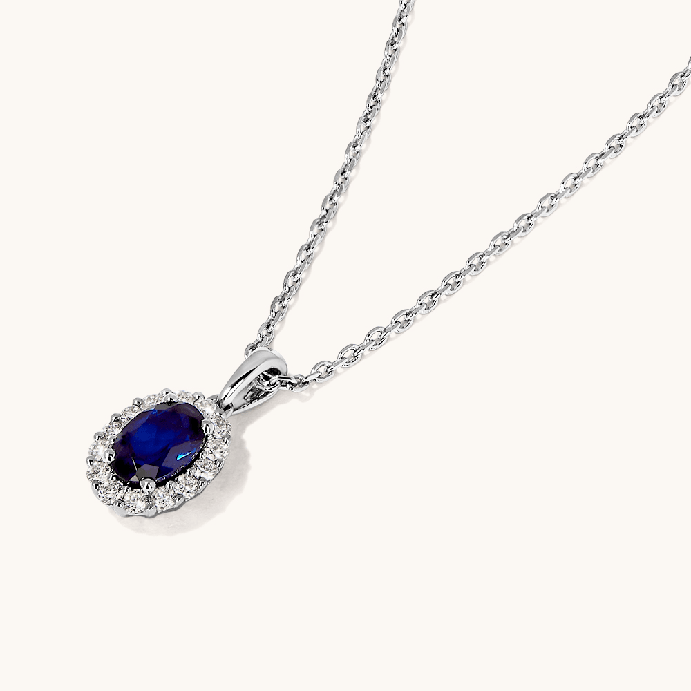 45cm Oval Created Sapphire Halo Pendant Necklace with 0.13tw of Laboratory-Grown Diamonds in Sterling Silver and Platinum Pendants Bevilles 
