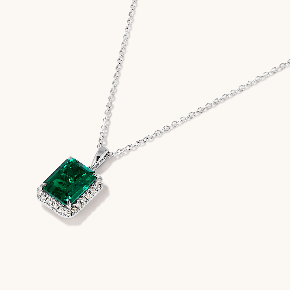 45cm Halo Oval Created Emerald Necklace with 0.18tw of Laboratory-Grown Diamonds in Sterling Silver and Platinum Pendants Bevilles 